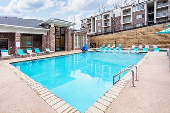 our apartments have a large swimming pool with chairs